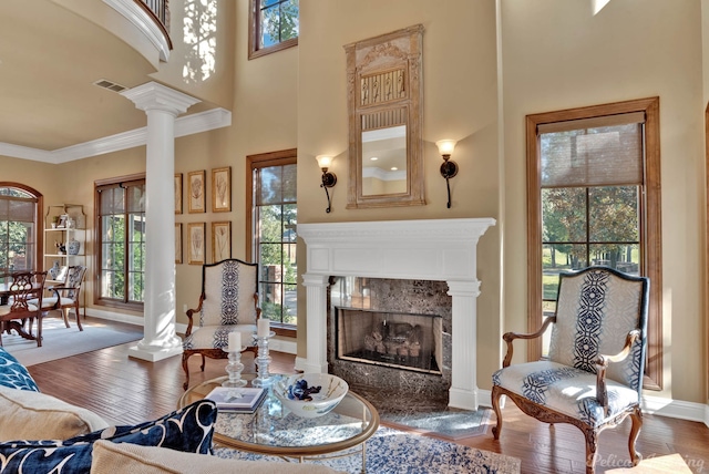 living room featuring hardwood / wood-style floors, a towering ceiling, and plenty of natural light