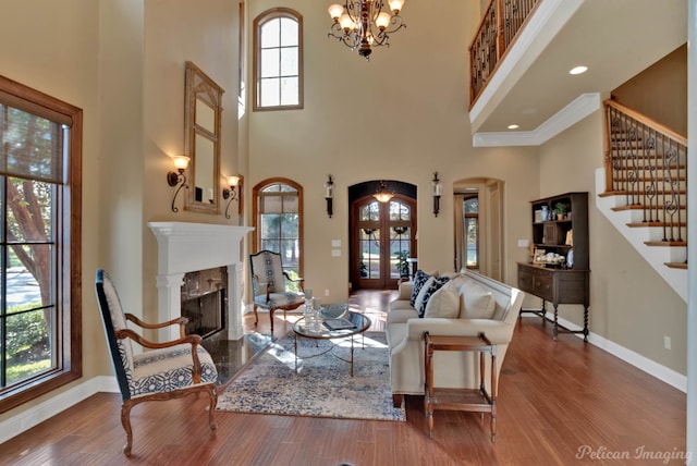 living room featuring hardwood / wood-style floors, a high ceiling, and plenty of natural light