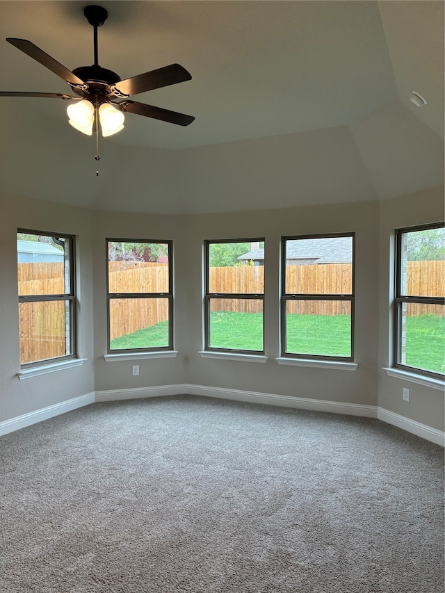 spare room with ceiling fan, carpet flooring, and a healthy amount of sunlight