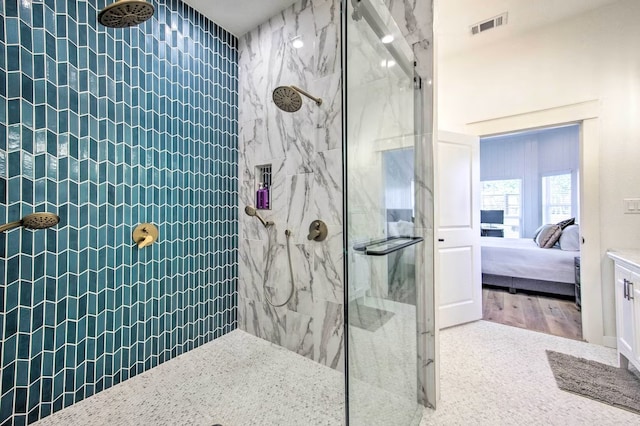 bathroom featuring hardwood / wood-style floors and a tile shower