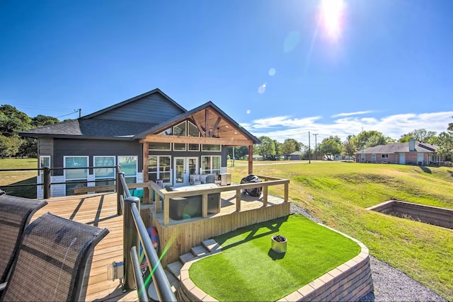 back of property featuring a yard and a wooden deck