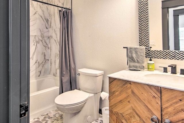 full bathroom featuring toilet, vanity, and shower / bathtub combination with curtain