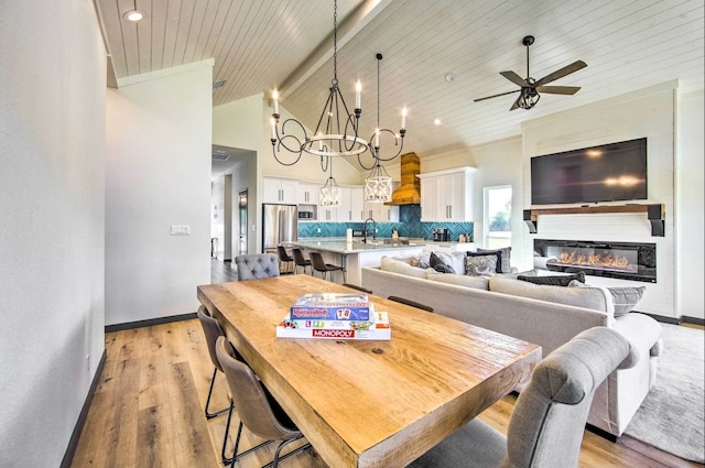 dining space with ceiling fan with notable chandelier, light hardwood / wood-style floors, lofted ceiling, and wooden ceiling