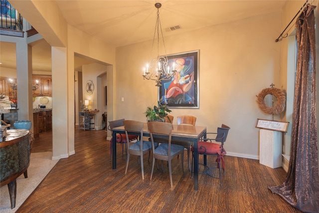 dining space featuring a notable chandelier and dark hardwood / wood-style floors