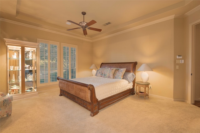 bedroom with carpet floors, a raised ceiling, ceiling fan, and ornamental molding