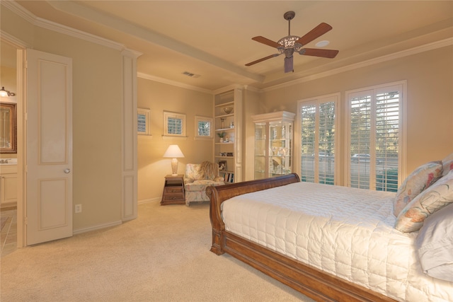 bedroom featuring ceiling fan, crown molding, and light colored carpet