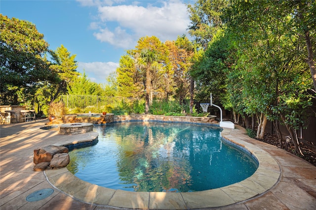 view of pool with a hot tub