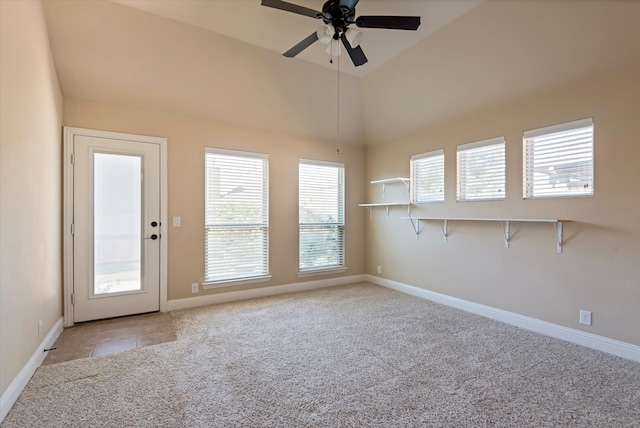 carpeted empty room featuring ceiling fan and vaulted ceiling