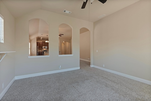 carpeted spare room with lofted ceiling and ceiling fan