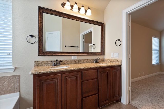 bathroom with a bathing tub and vanity