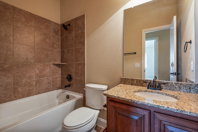 full bathroom featuring vanity, toilet, and tiled shower / bath