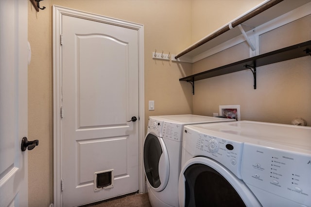 clothes washing area with washing machine and dryer