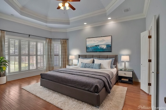 bedroom with light wood-type flooring, ceiling fan, and crown molding