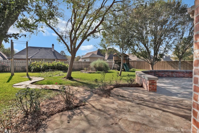 view of yard featuring a playground and a patio area