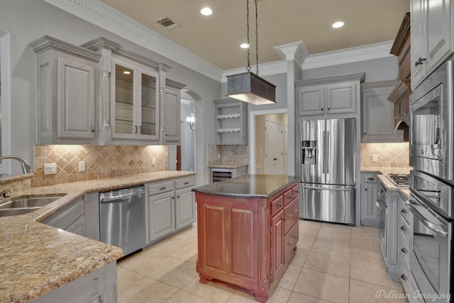 kitchen featuring sink, crown molding, pendant lighting, gray cabinets, and appliances with stainless steel finishes