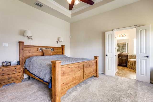 carpeted bedroom with ensuite bath, ceiling fan, and crown molding