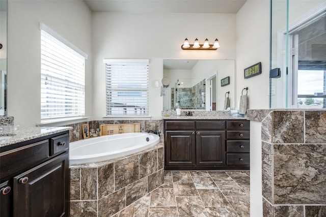 bathroom with independent shower and bath and vanity