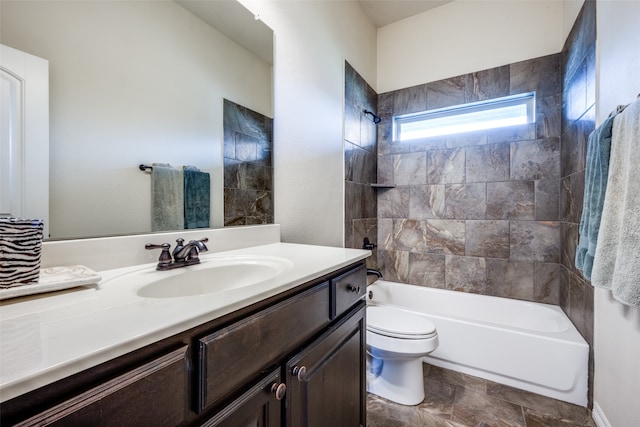 full bathroom with vanity, tiled shower / bath combo, and toilet