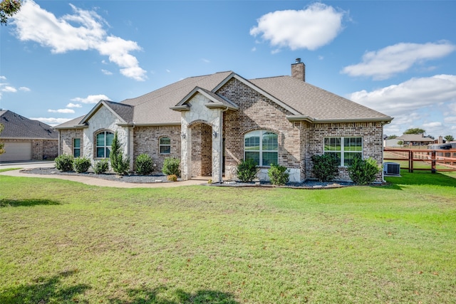 view of front of property with a garage and a front lawn