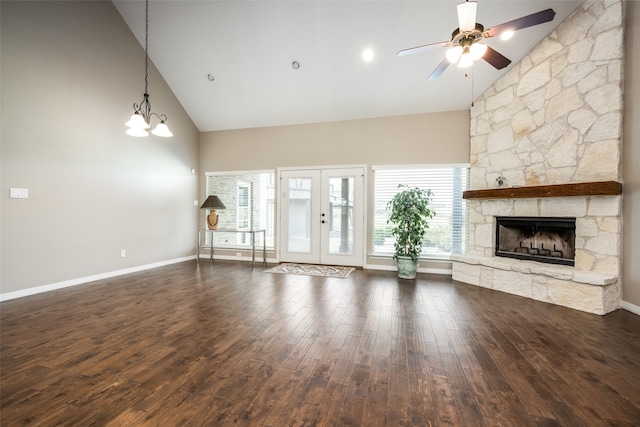 unfurnished living room featuring dark wood-type flooring, a fireplace, and high vaulted ceiling