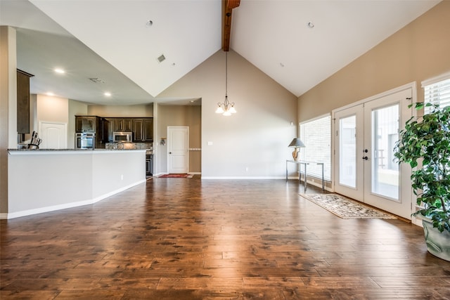 unfurnished living room with french doors, dark wood-type flooring, and high vaulted ceiling