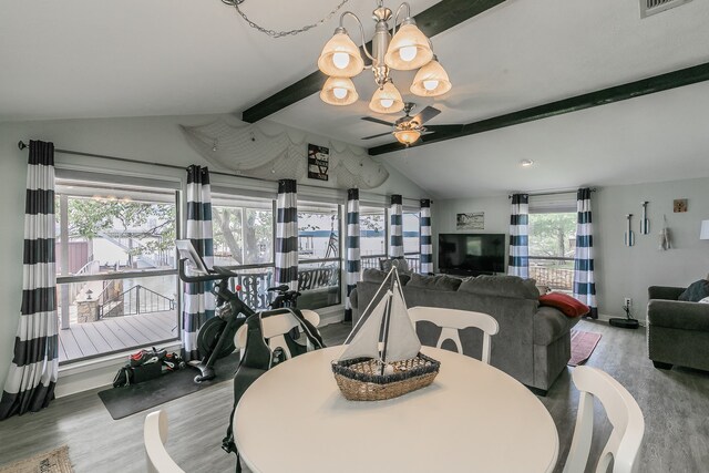 dining room with lofted ceiling with beams, wood-type flooring, and ceiling fan with notable chandelier