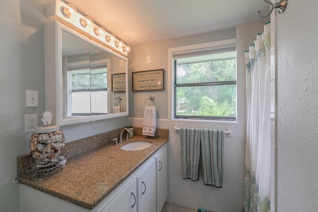 bathroom featuring tile walls and vanity