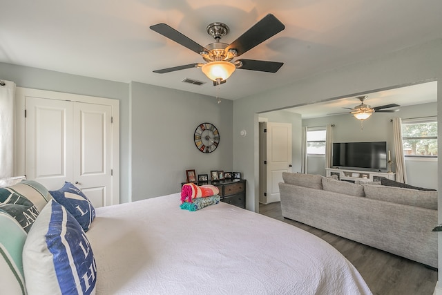 bedroom with hardwood / wood-style floors, ceiling fan, and a closet