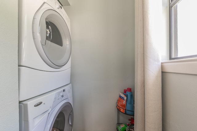 laundry area featuring stacked washer and dryer