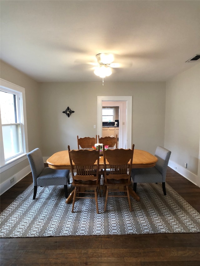 dining room with dark hardwood / wood-style floors and ceiling fan