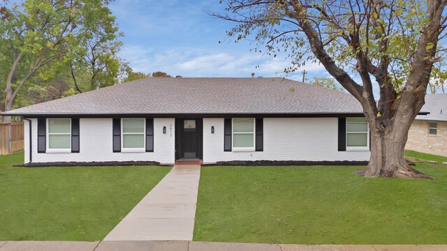 ranch-style home with a front lawn