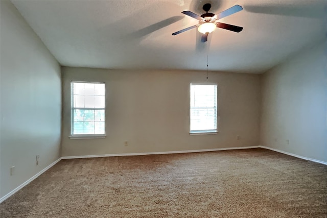 carpeted empty room featuring a healthy amount of sunlight and ceiling fan