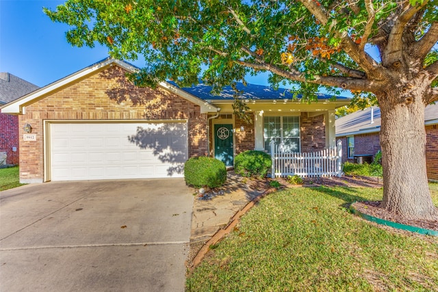 ranch-style house featuring a front yard, a porch, and a garage