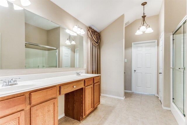 bathroom with a chandelier, vanity, tile patterned flooring, and walk in shower