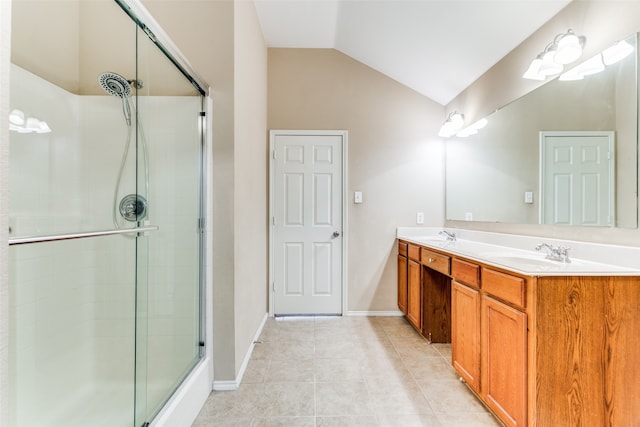 bathroom featuring tile patterned floors, vanity, vaulted ceiling, and a shower with shower door