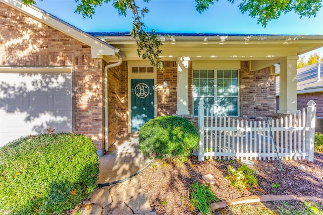 property entrance with a porch and a garage