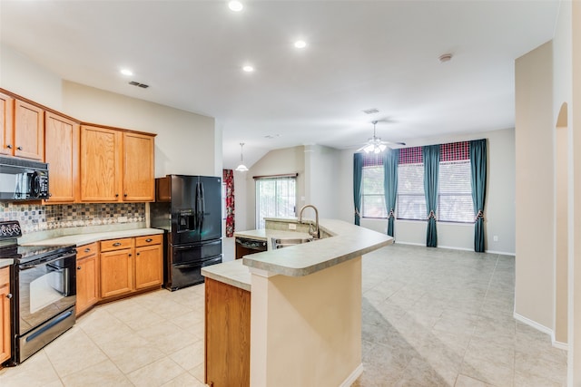 kitchen featuring decorative backsplash, ceiling fan, sink, black appliances, and an island with sink