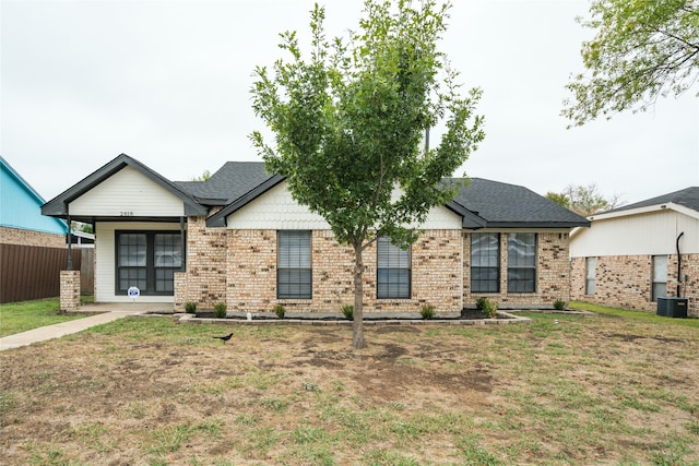 ranch-style house with central AC unit and a front lawn