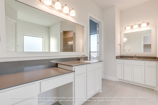 bathroom with tile patterned flooring, two vanities, and a sink