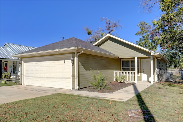 view of front of home featuring a garage, a front yard, and a porch