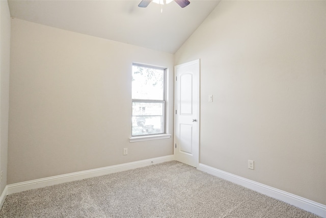 carpeted empty room featuring lofted ceiling and ceiling fan