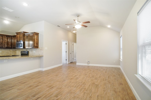 unfurnished living room with light wood-type flooring, ceiling fan, and vaulted ceiling