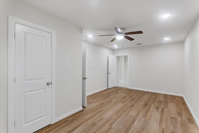 spare room with light hardwood / wood-style floors and ceiling fan