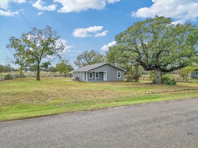 view of home's exterior with a lawn and a rural view