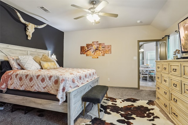 carpeted bedroom with vaulted ceiling and ceiling fan