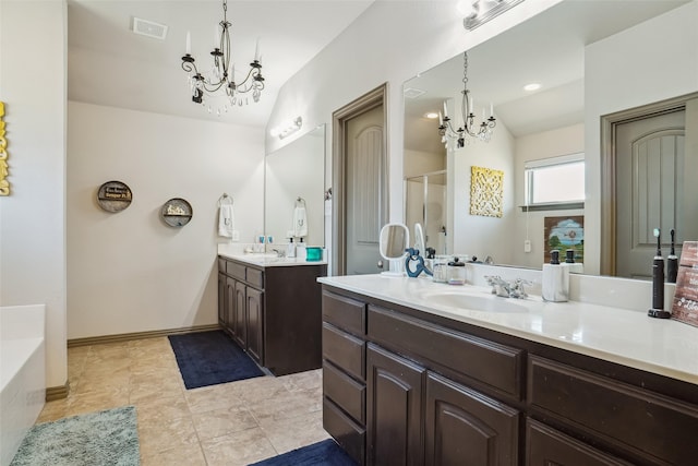 bathroom with a chandelier, vanity, vaulted ceiling, and tile patterned flooring