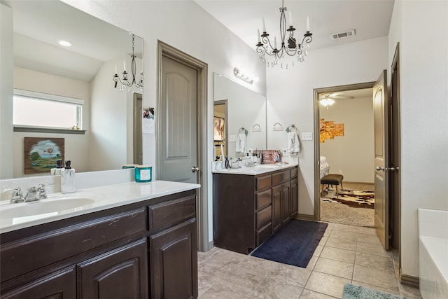 bathroom featuring tile patterned floors, vanity, vaulted ceiling, and a notable chandelier