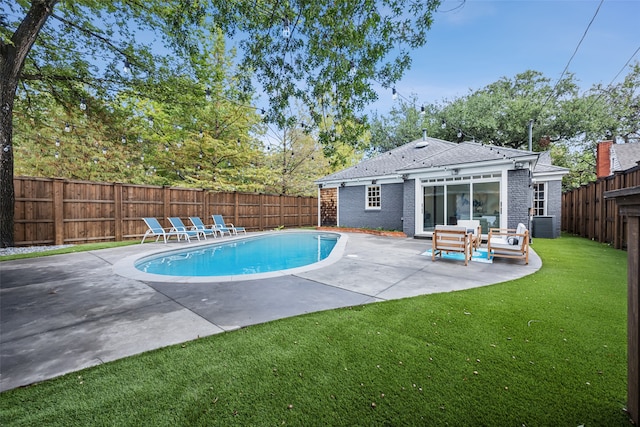 view of swimming pool with a yard and a patio area