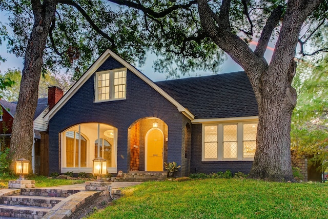 tudor-style house with a lawn