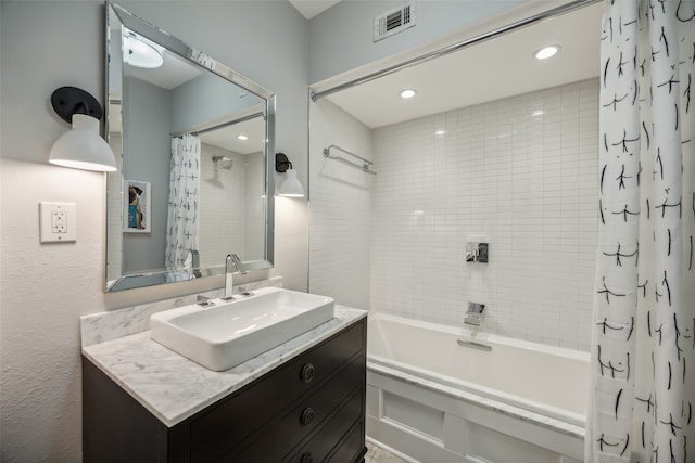 bathroom with shower / tub combo with curtain and vanity